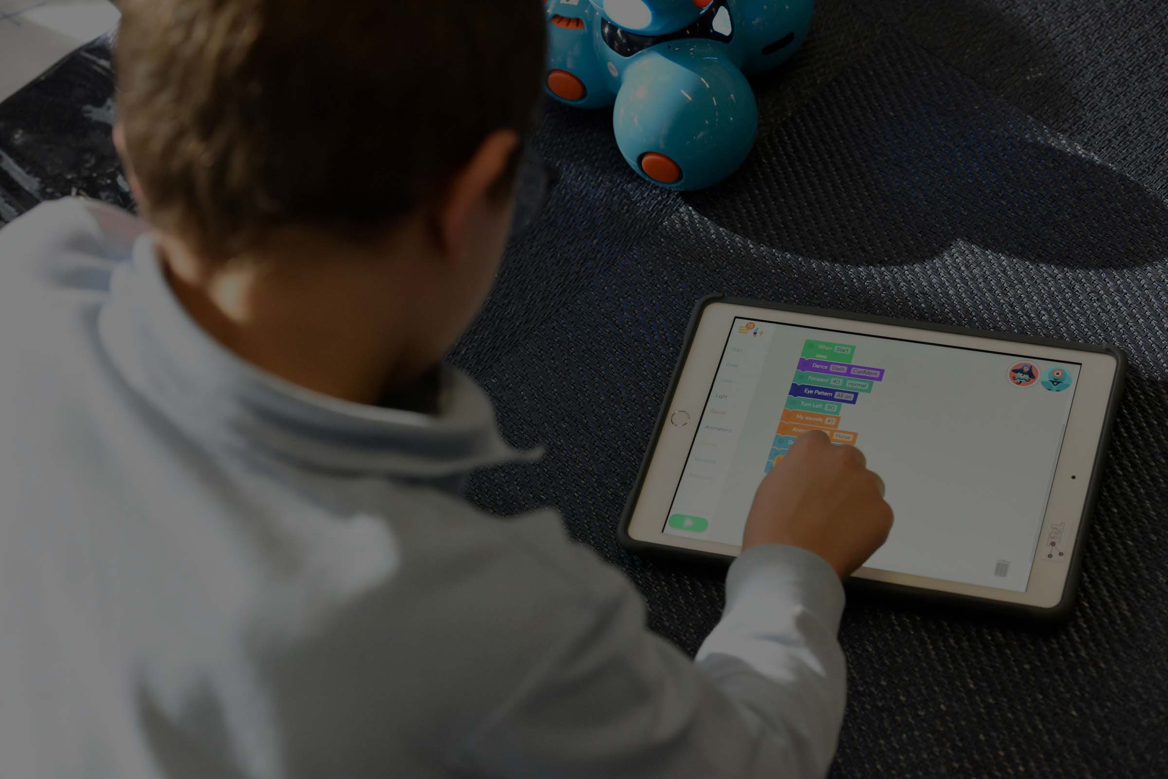 Child coding on iPad